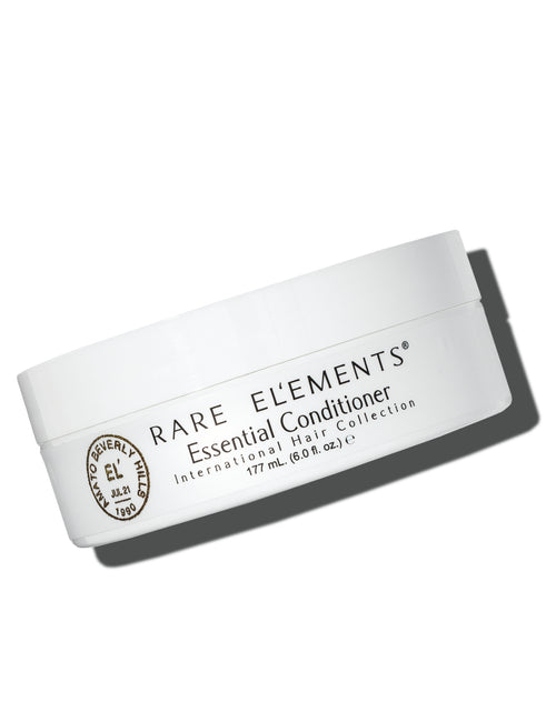 White container of Rare Elements Essential Daily Mask Conditioner on a white background
